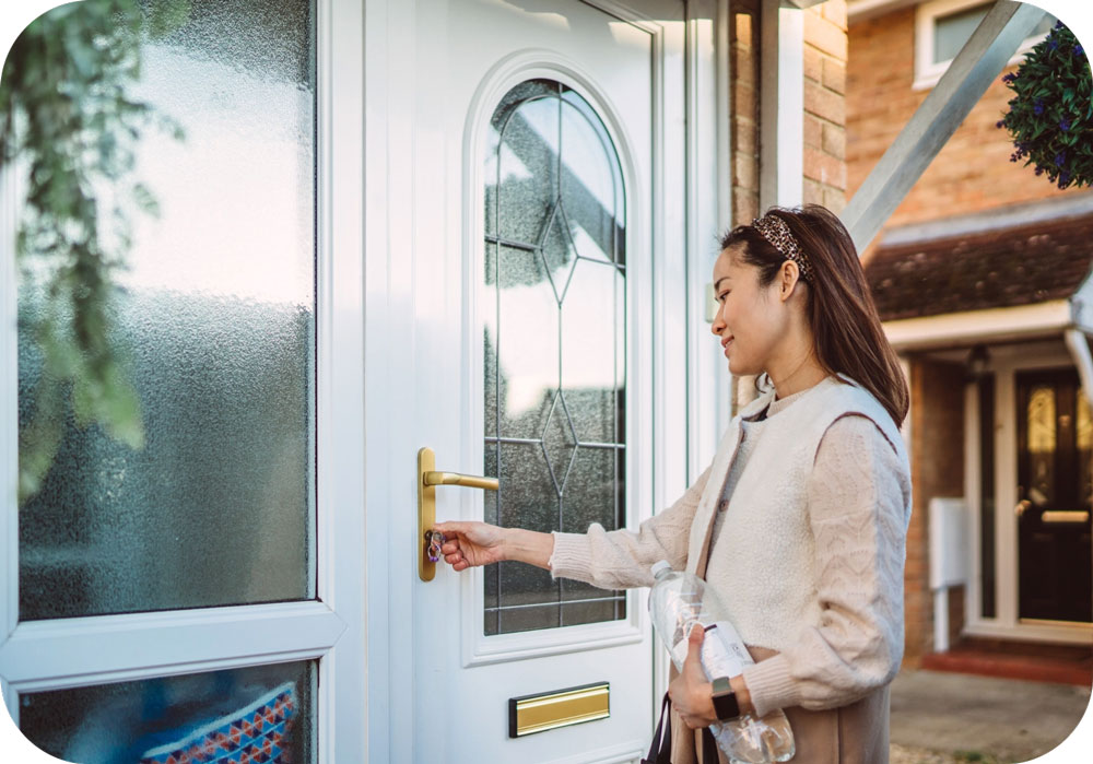 Happy Woman Locking Front Door